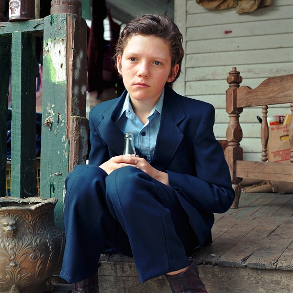 Boy Seated on Porch with Soda