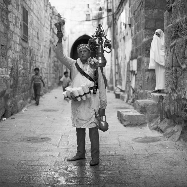 Elder Man Ringing Bell in Street